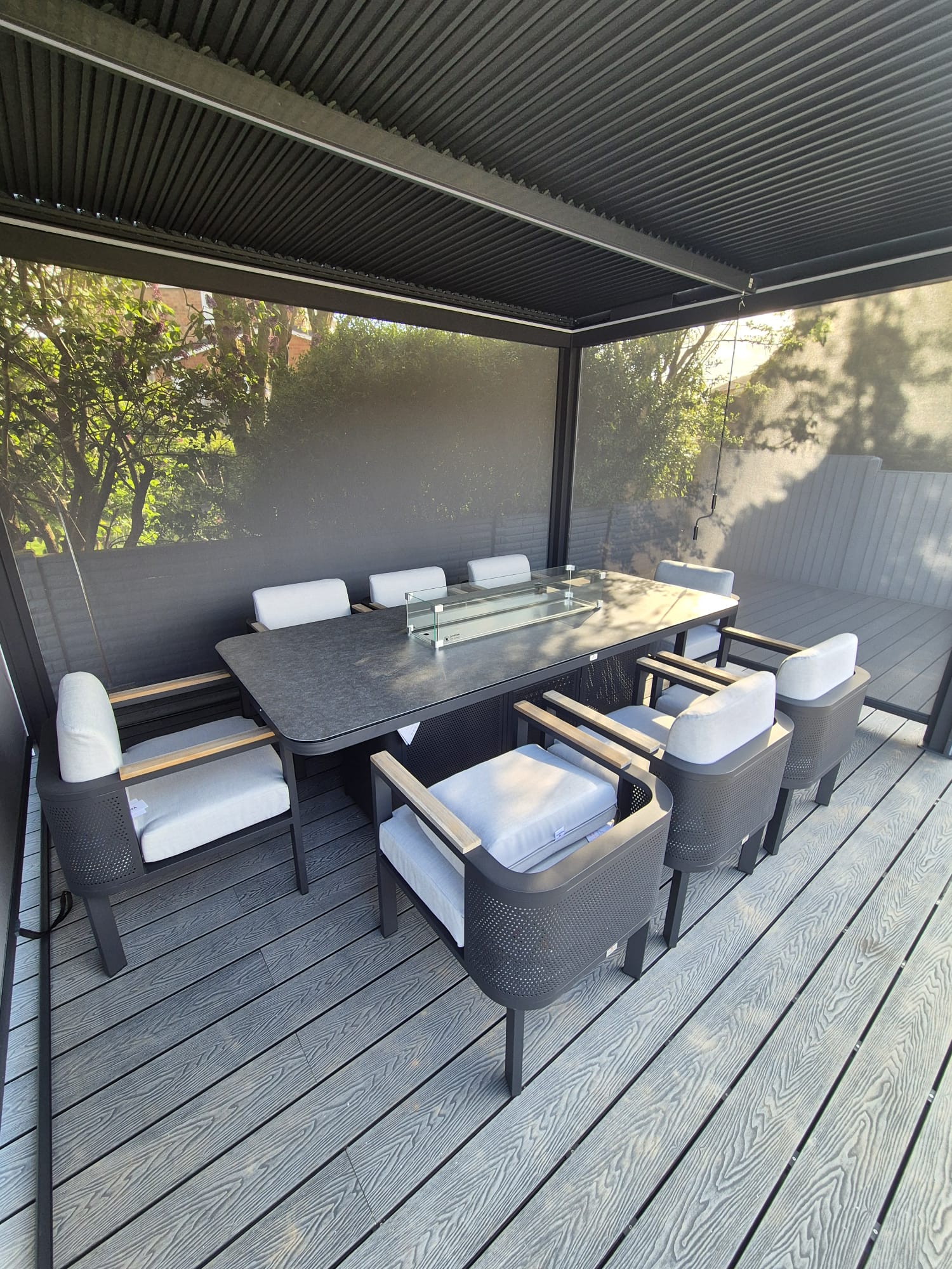 Luxury composite decking under timber pergola with dining area